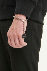 GULNOZA DILNOZA Logo pendant bracelet in silver finish metal