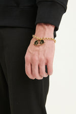 Load image into Gallery viewer, GULNOZA DILNOZA Logo pendant bracelet in gold finish metal
